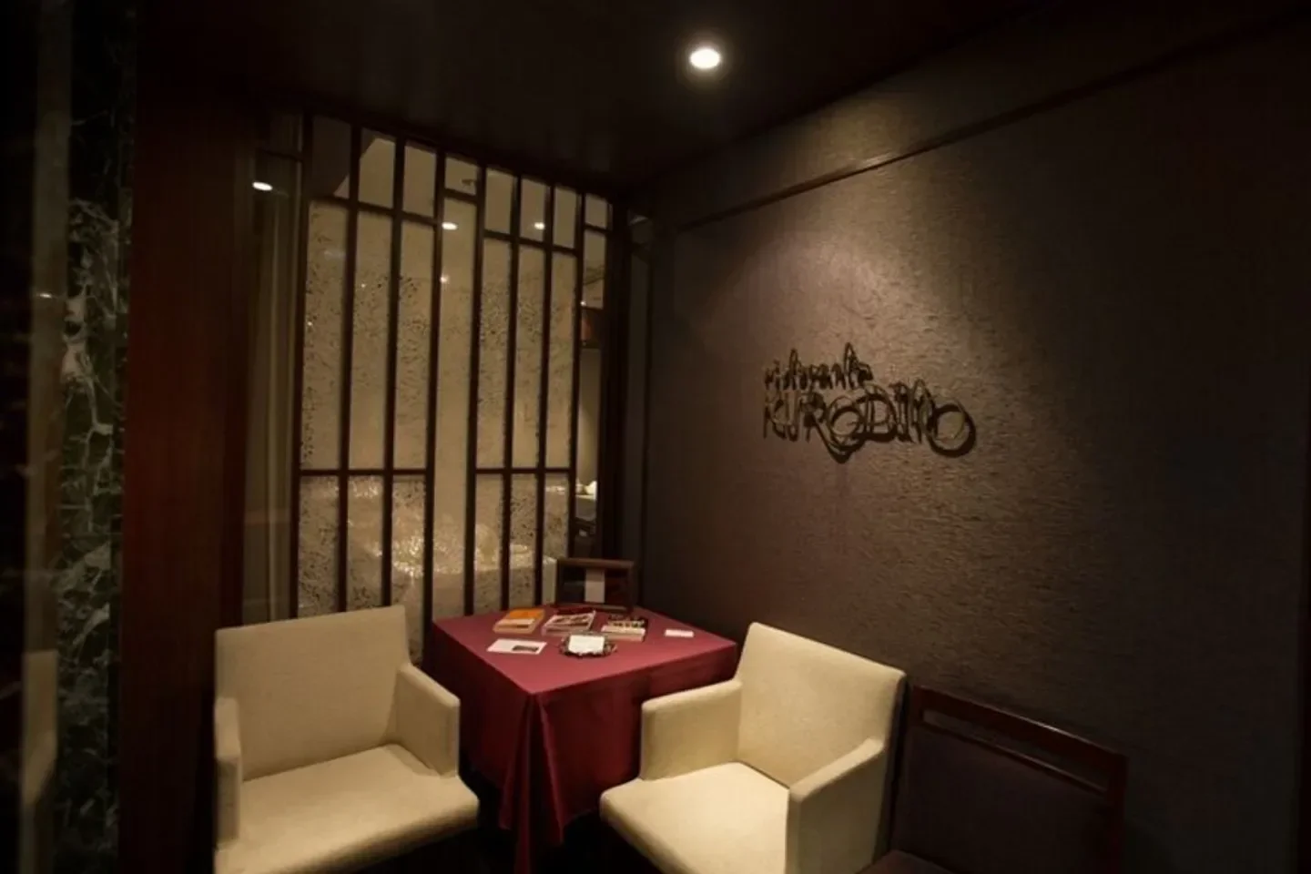 Cozy seating area at Ristorante KURODINO in Tokyo, featuring stylish interior design.