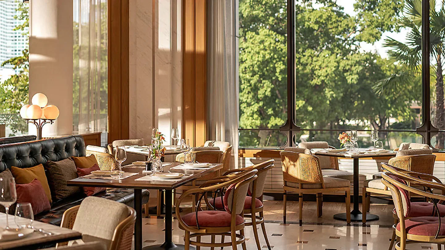 Elegant dining at Riva Del Fiume restaurant in Bangkok with natural light and views