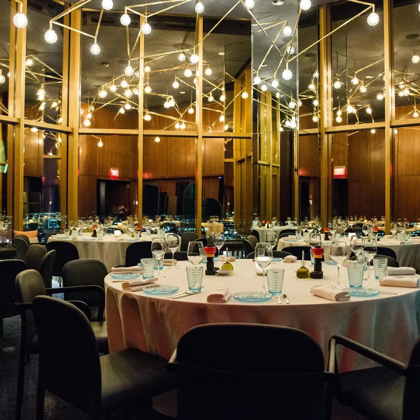 Elegant dining room interior at Rivea restaurant in Las Vegas, with city views.