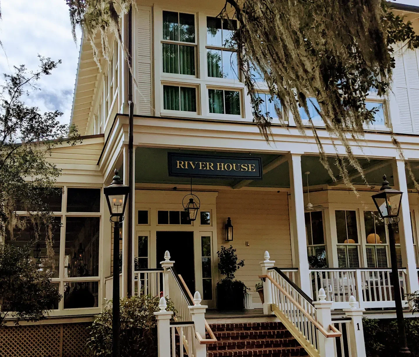 River House restaurant exterior in Hilton Head Island, with porch and stairs in daytime
