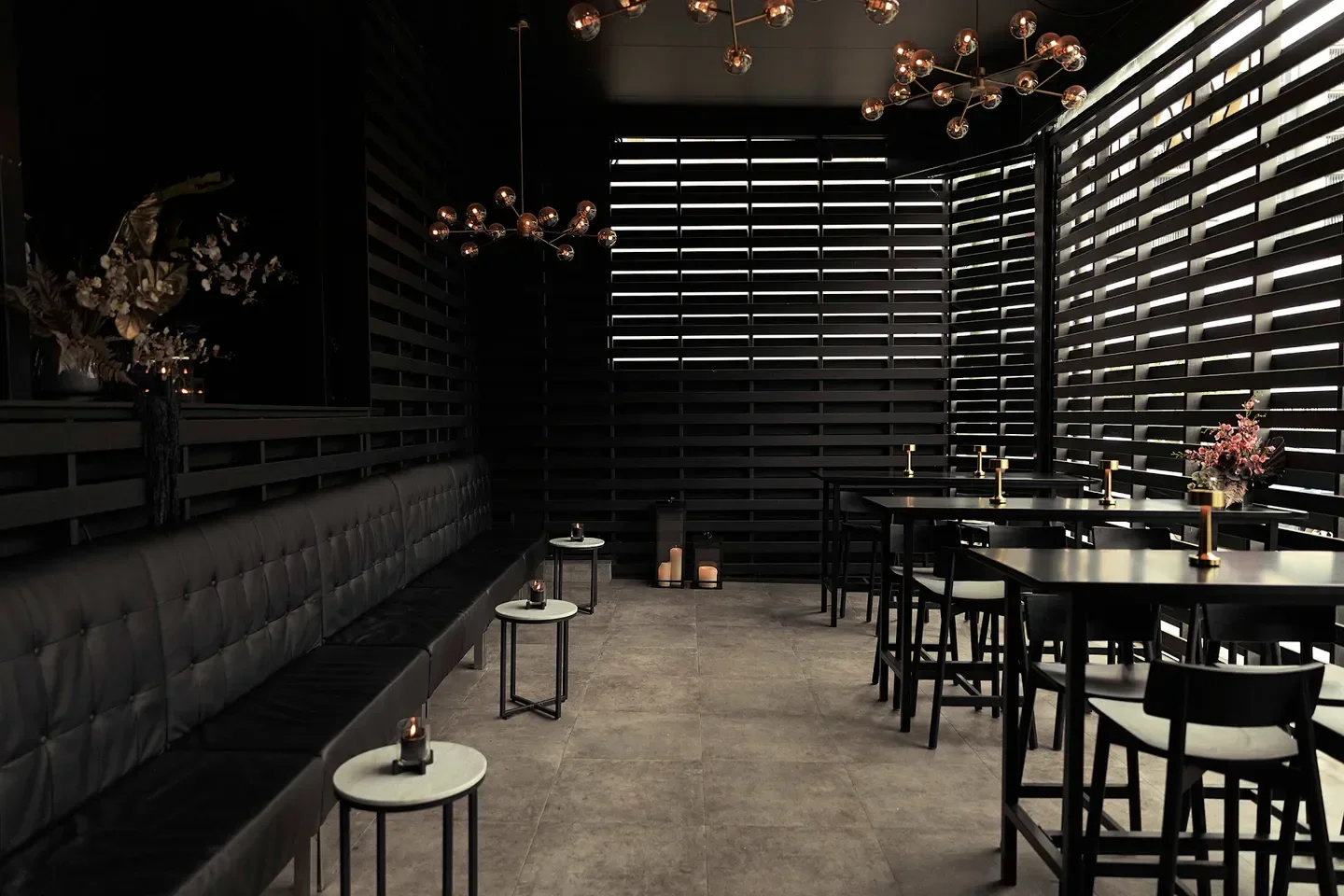 Stylish interior of Rogue Bistro in Brisbane, featuring black decor and elegant lighting.