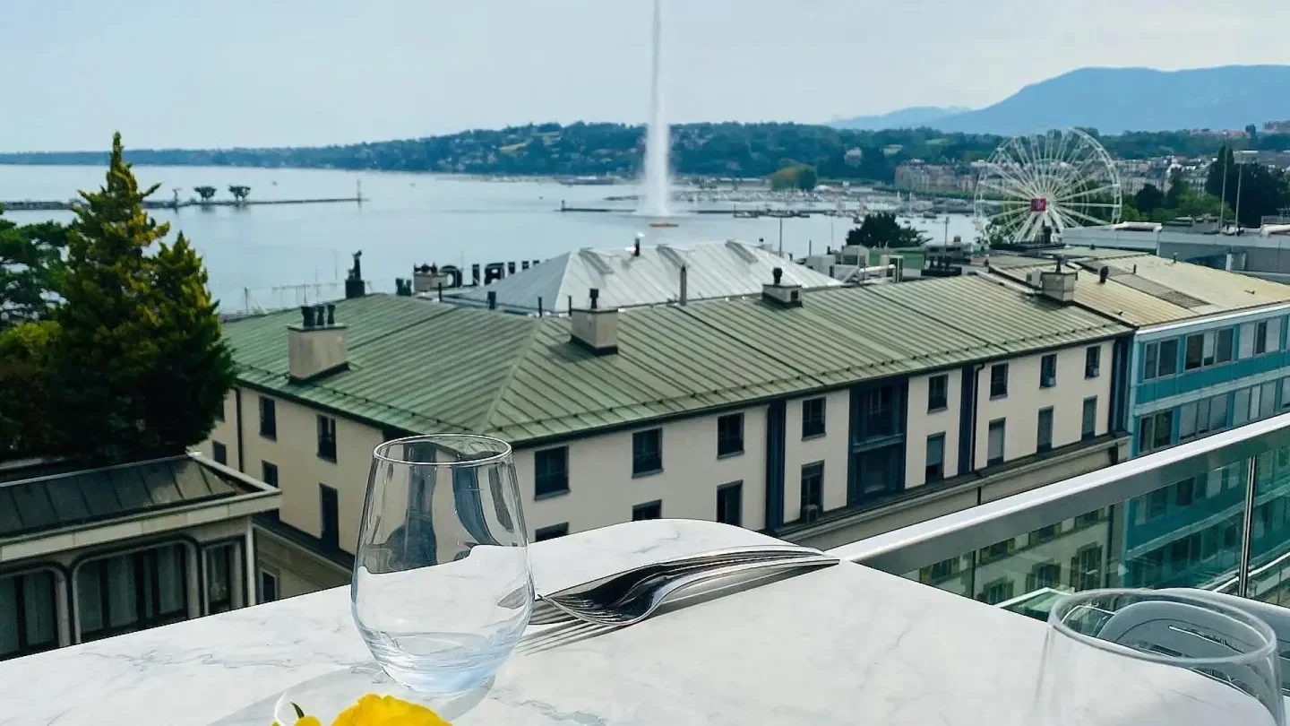 Table setting with Geneva lake view at Rooftop 42 restaurant, including water fountain.