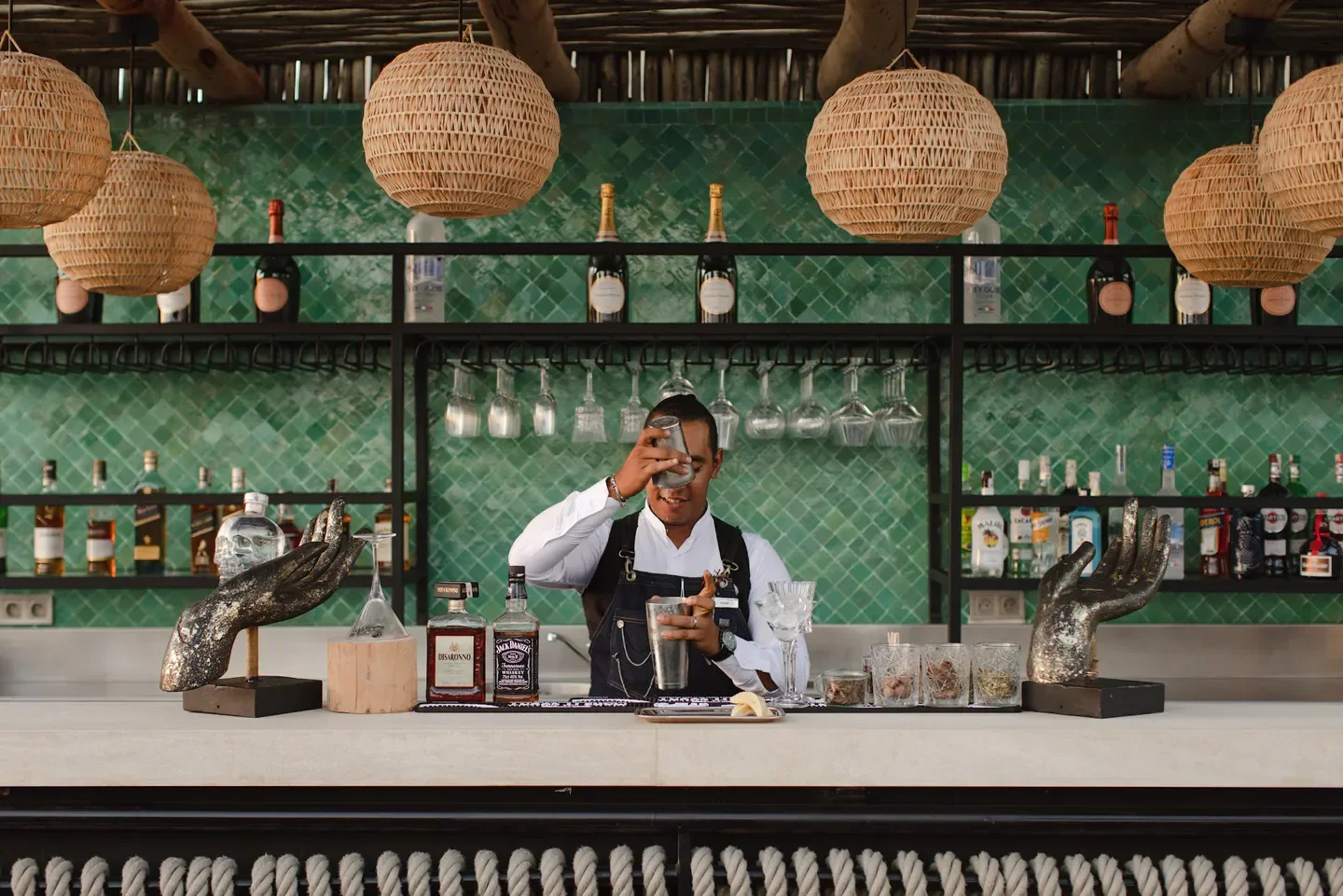 Stylish bar at Rooftop Garden in Marrakech, bartender preparing a cocktail.
