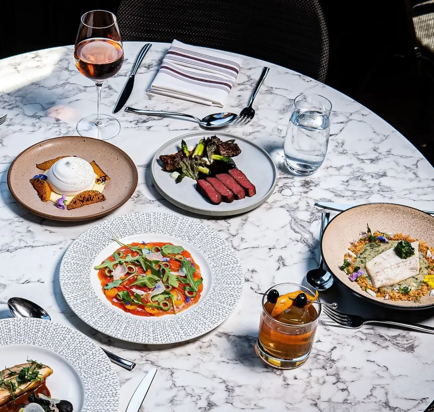 Delicious dishes on marble table at Rooster & Owl restaurant in Washington.