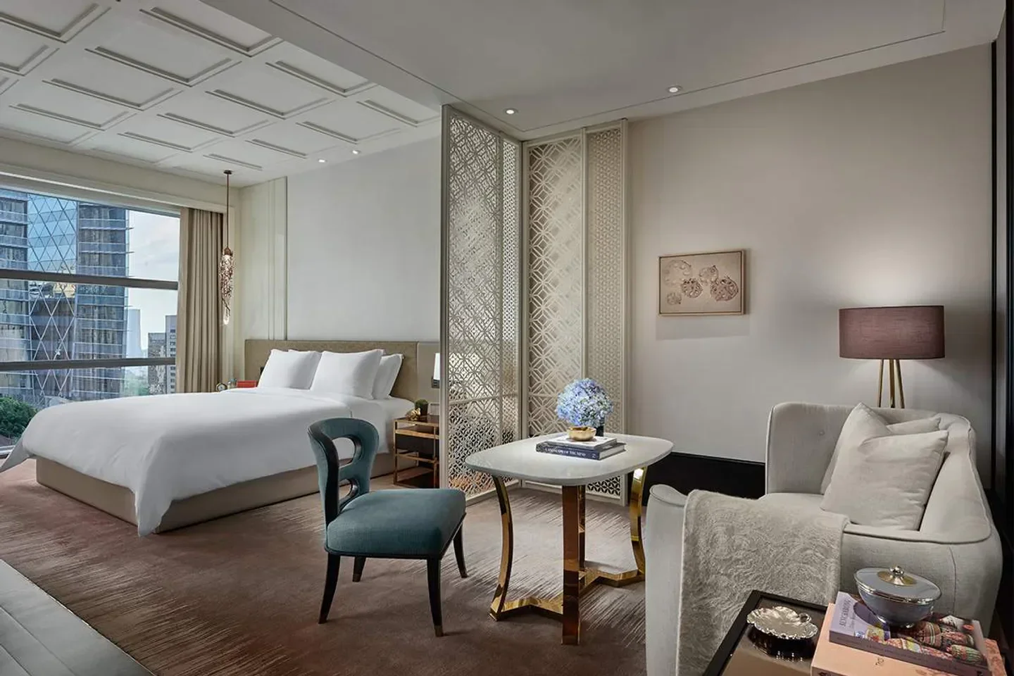 Elegant hotel suite at Rosewood Bangkok, featuring stylish decor and city views.