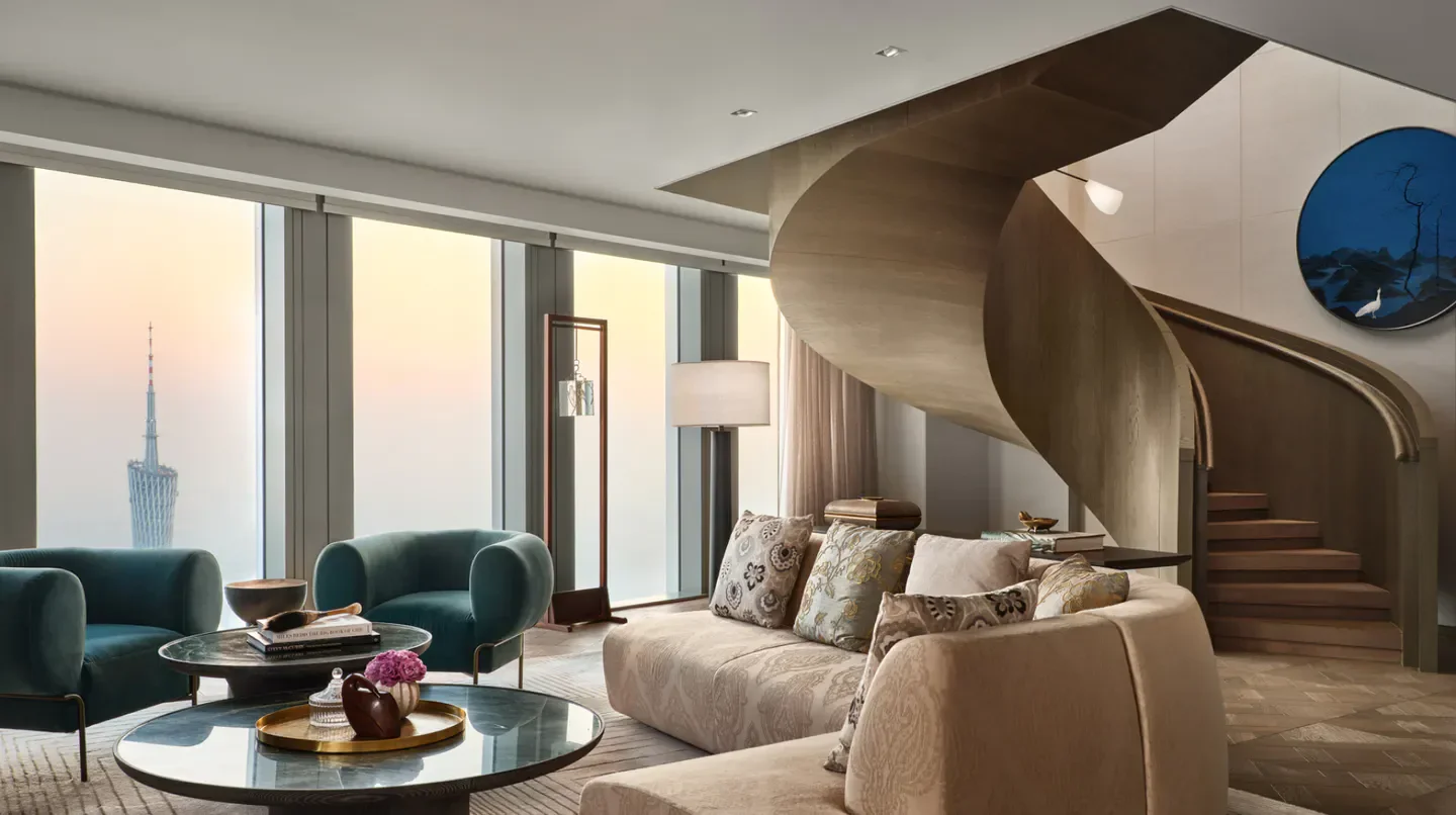 Elegant interior at Rosewood Guangzhou with a spiral staircase overlooking the city.