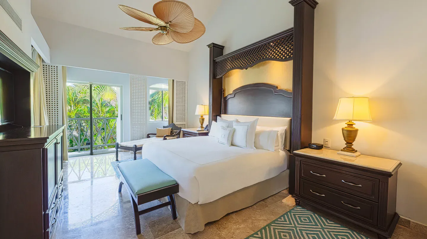 Elegant bedroom at Royal Hideaway Playacar in Playa del Carmen, with balcony view.