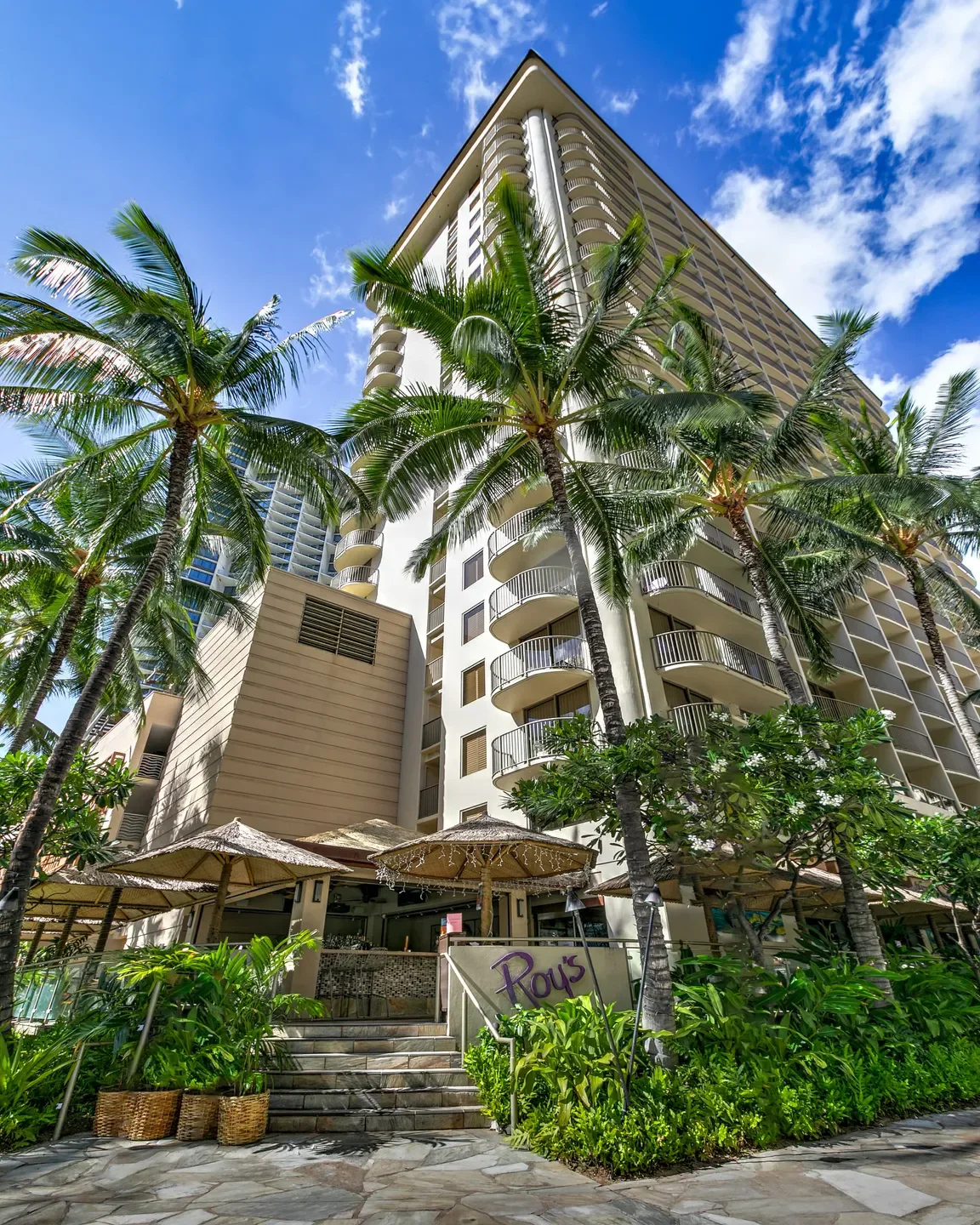 Entrance to Roy's - Ko Olina Golf Course in Honolulu, with tropical landscaping and building.