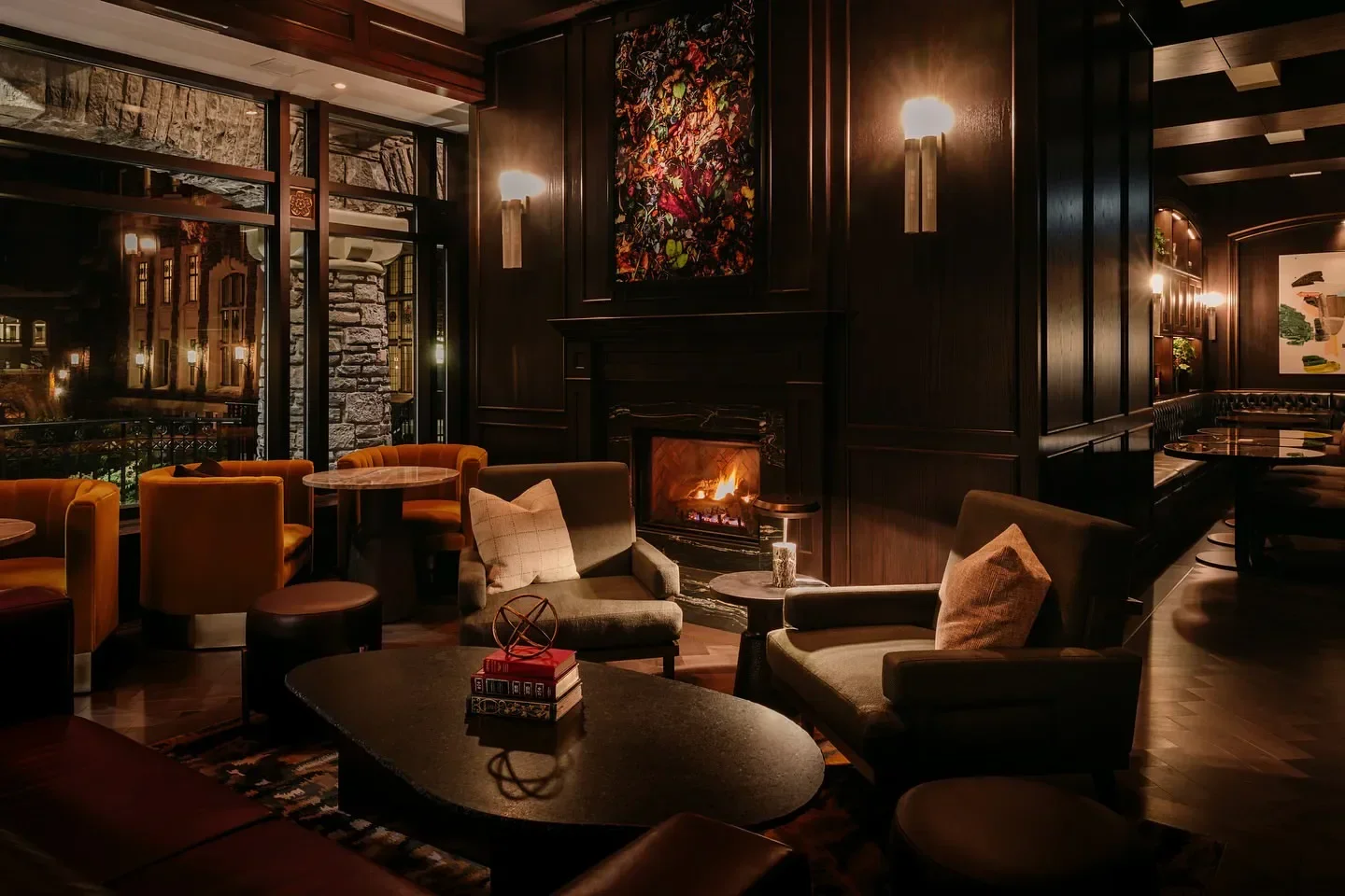 Cozy interior of Rundle Bar in Banff, featuring fireplace and elegant seating area.