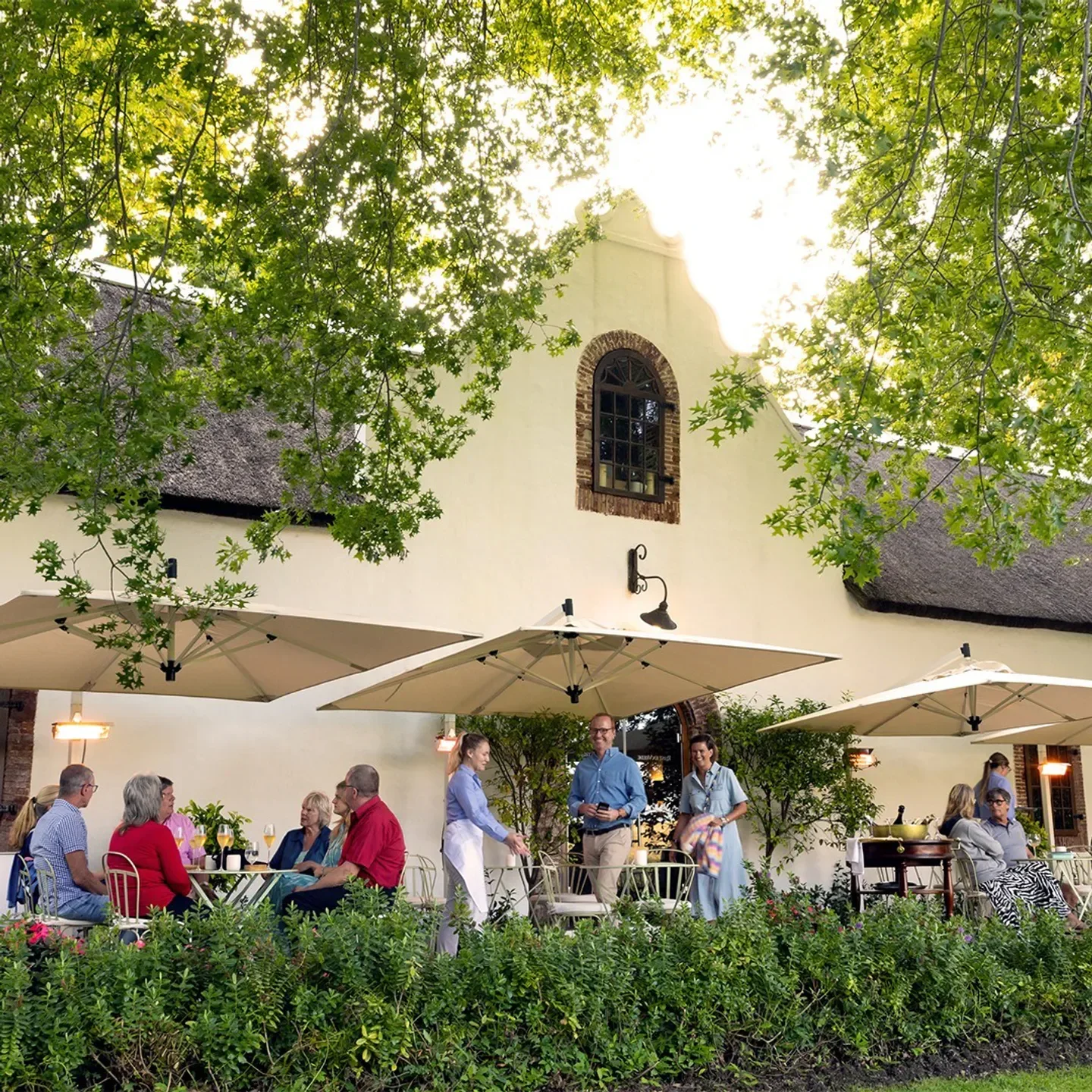 Outdoor dining at Rust en Vrede restaurant in Stellenbosch, with guests enjoying the day.
