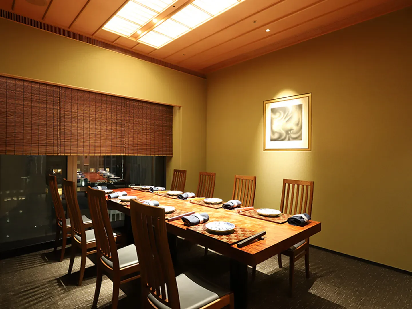 Elegant dining room at Ryugin restaurant in Tokyo, showcasing a meticulously set table.