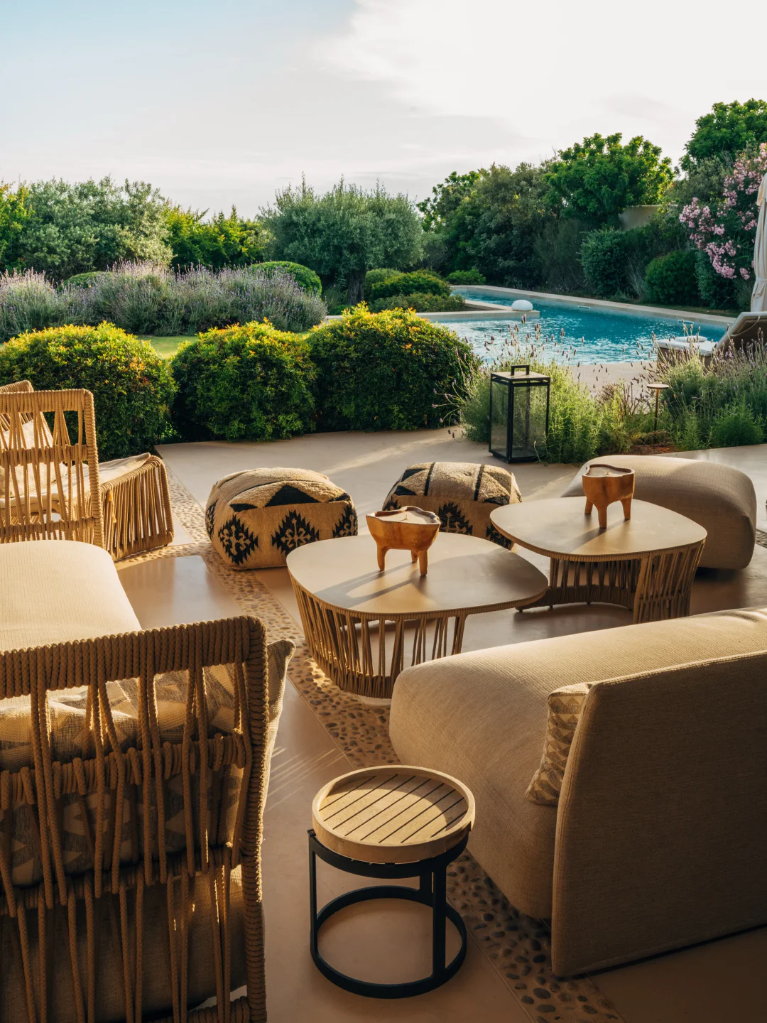 Relaxing outdoor lounge area with seating and pool views at Sabina Clubhouse, the city