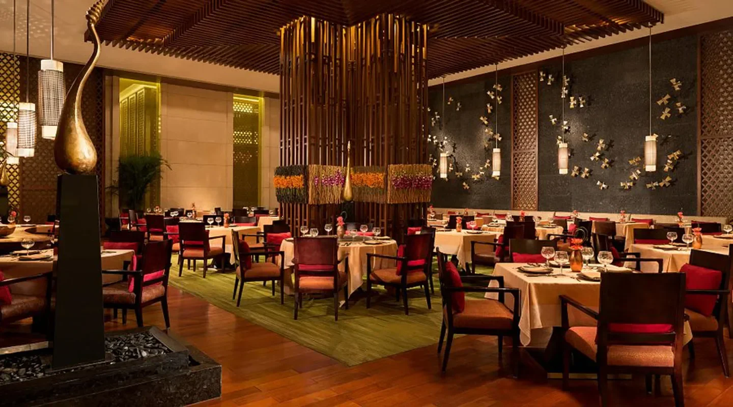 Elegant dining area inside Saffron restaurant in Macau, with sophisticated table settings.