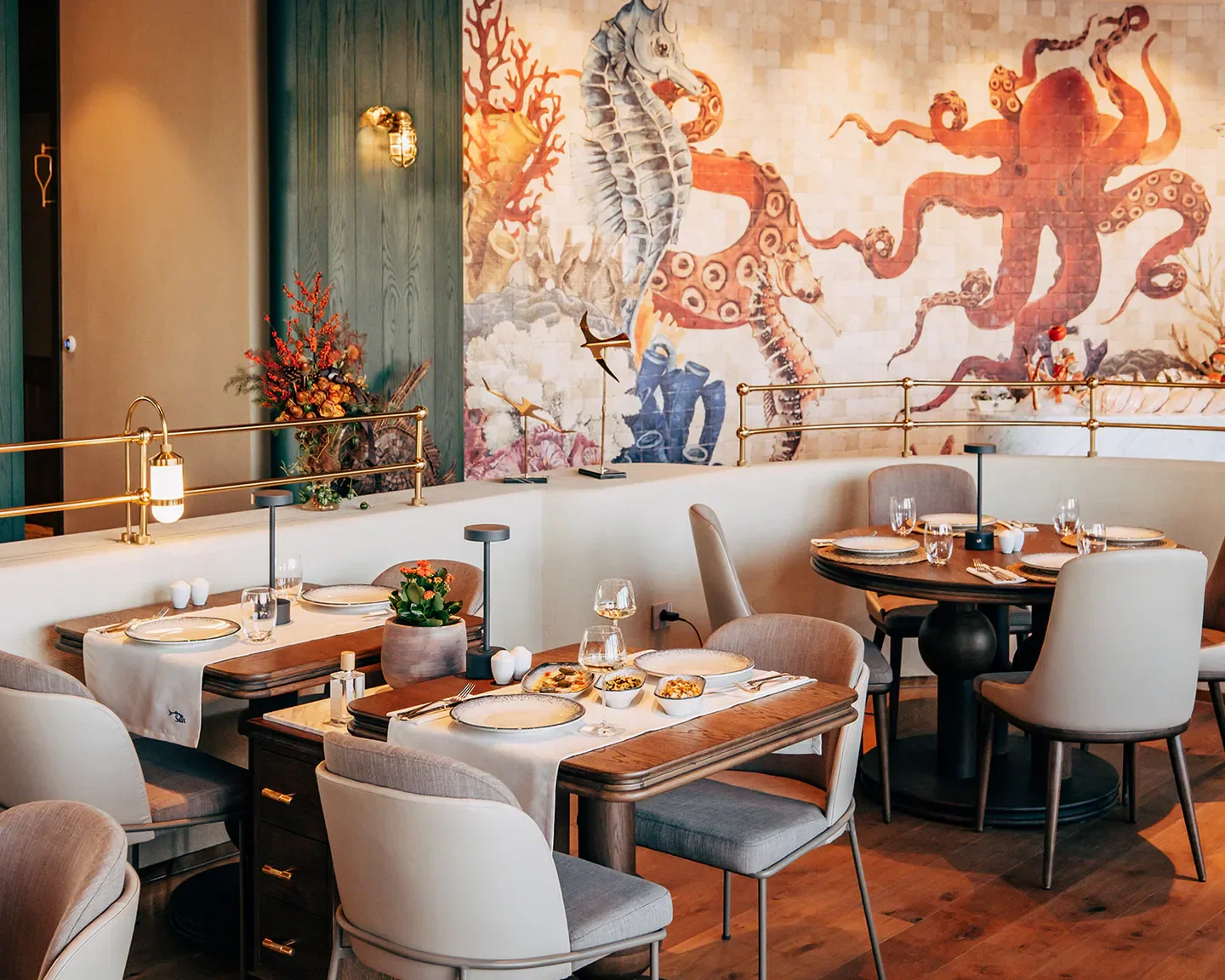 Elegant interior of Sait restaurant in Istanbul, featuring unique mural and stylish dining tables.