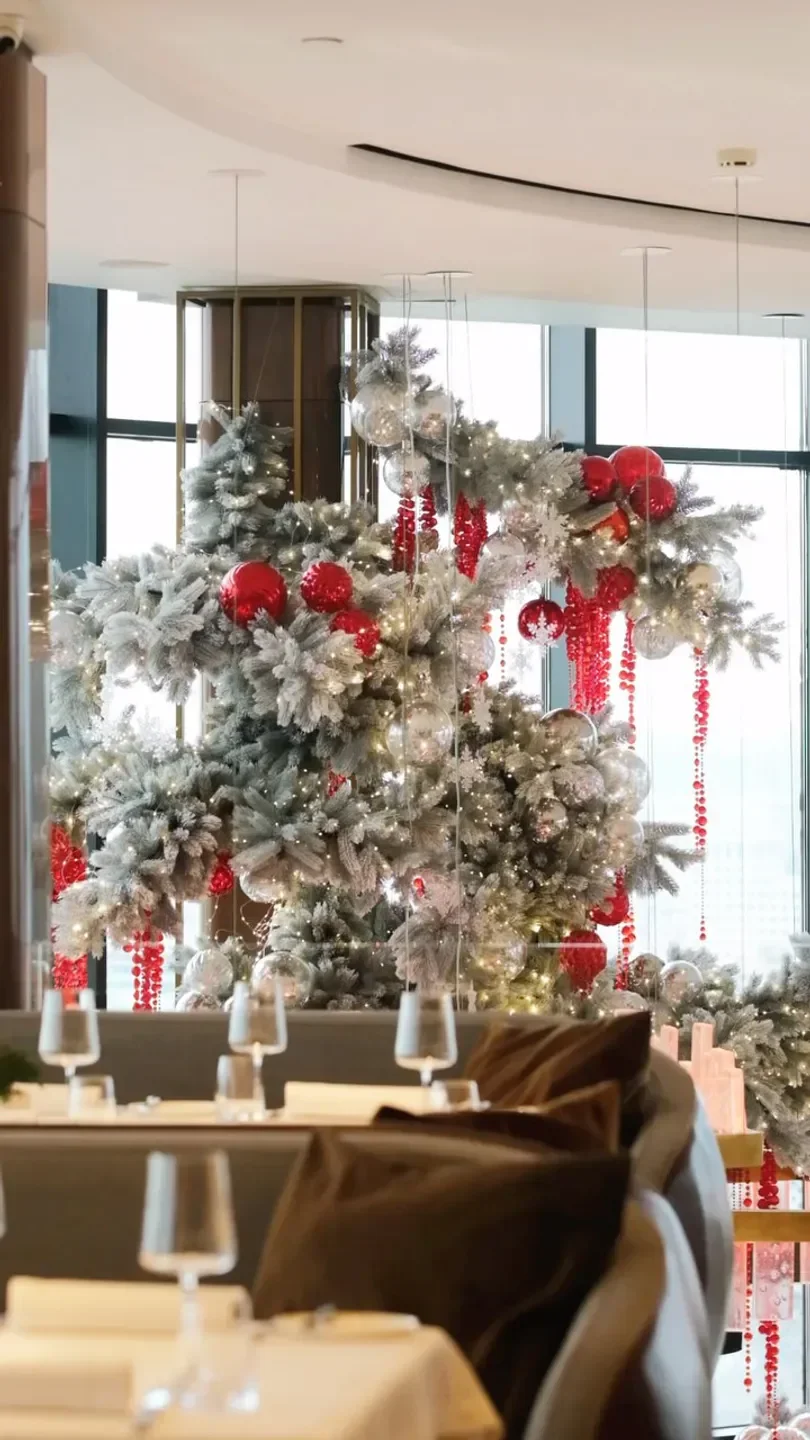 Festive decor at Sakhalin restaurant in Moscow, featuring elegant Christmas trees.