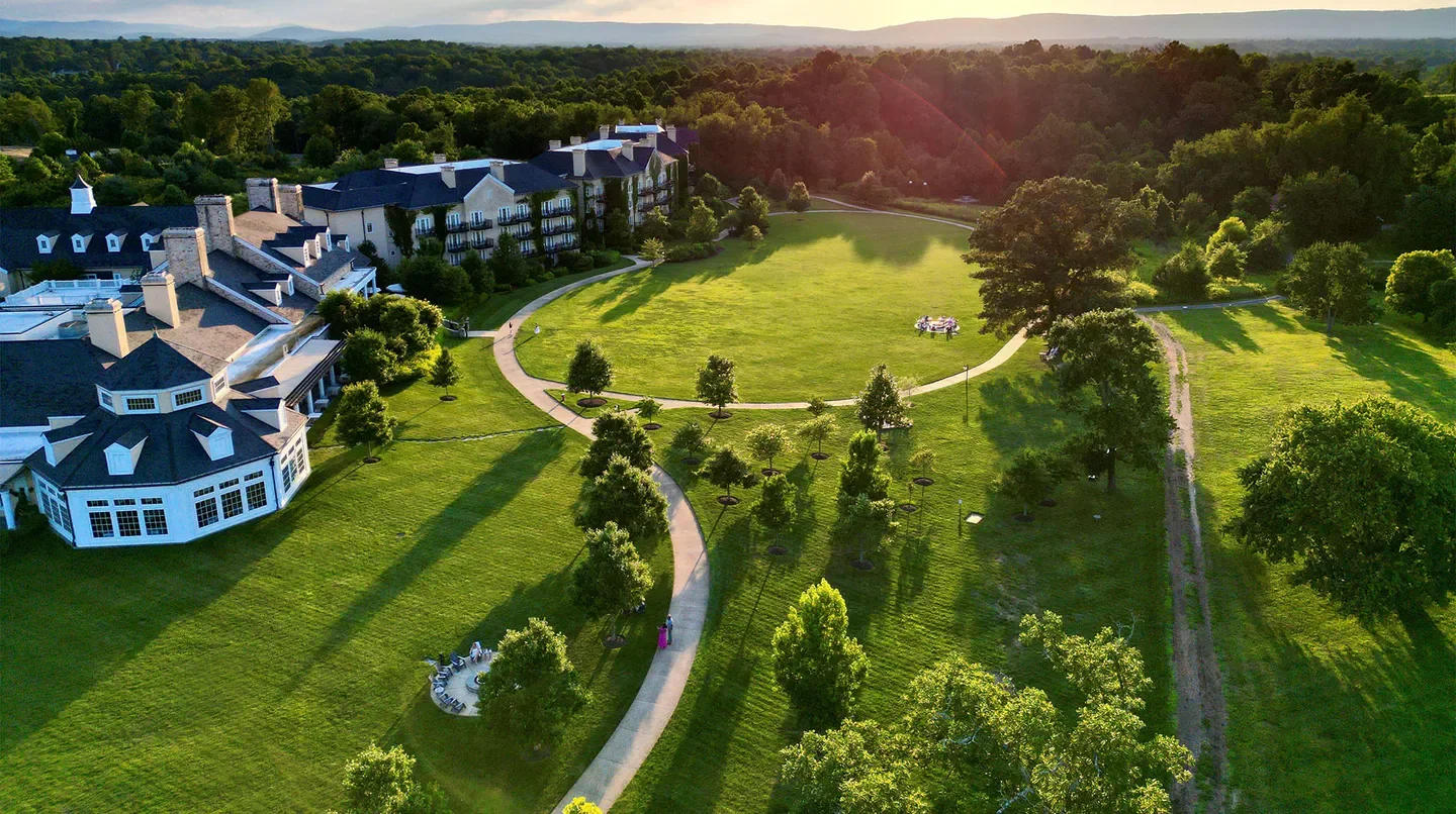Aerial view of Salamander Middleburg hotel in Charlottesville, Virginia, with lush greenery.