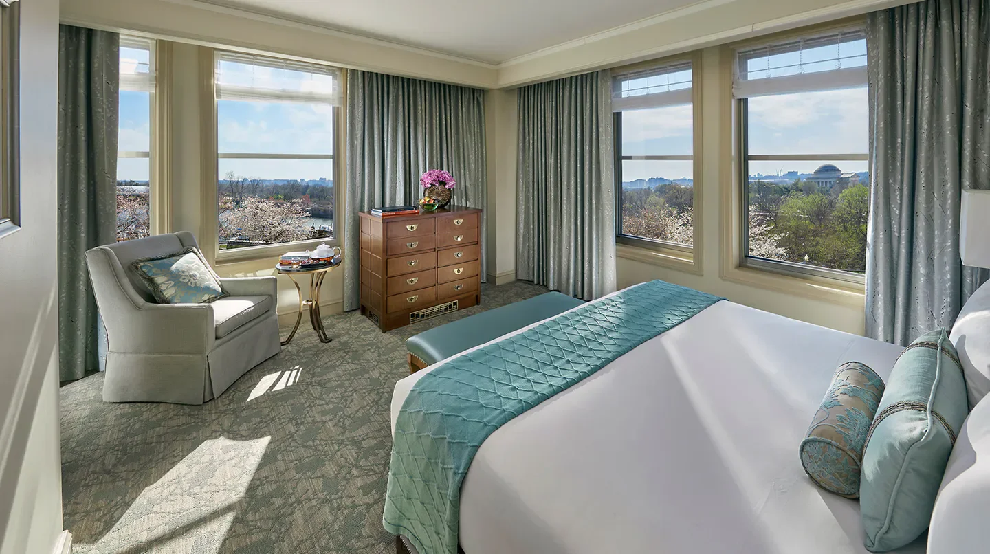Elegant bedroom at Salamander Washington DC, with views of Washington and cherry blossoms.
