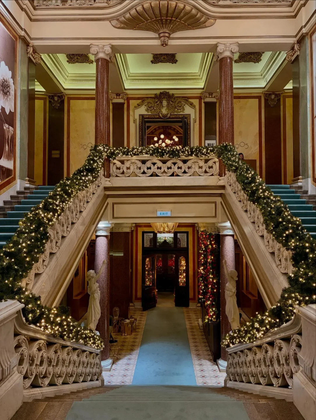 Stunning interior view of Salon 1905 in Belgrade, featuring grand staircase with festive decor and elegant architecture.