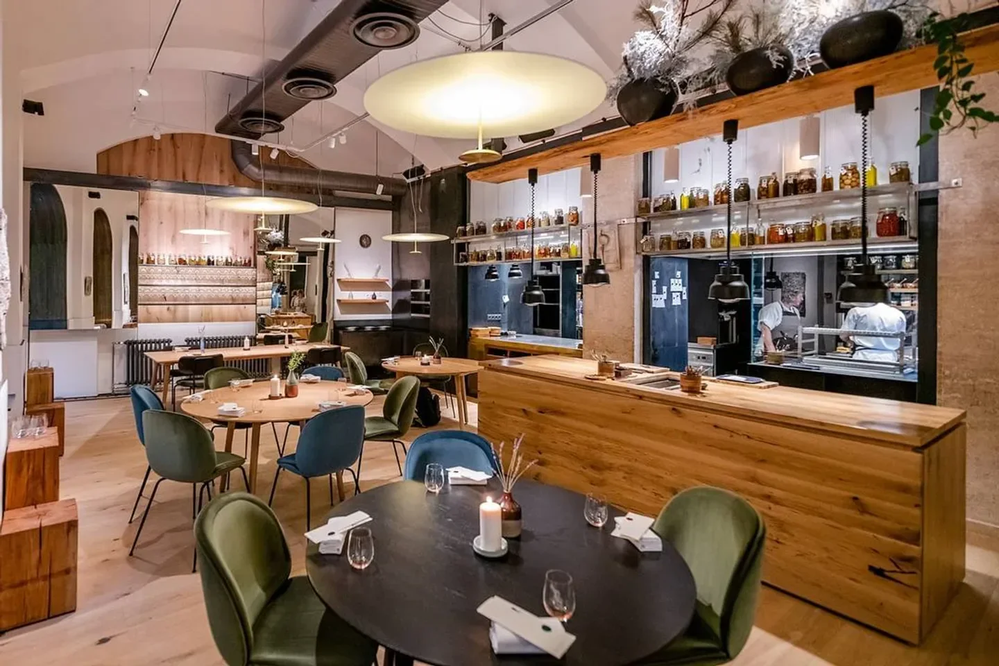 Interior of Salt restaurant in Budapest, featuring a stylish dining room and kitchen area.