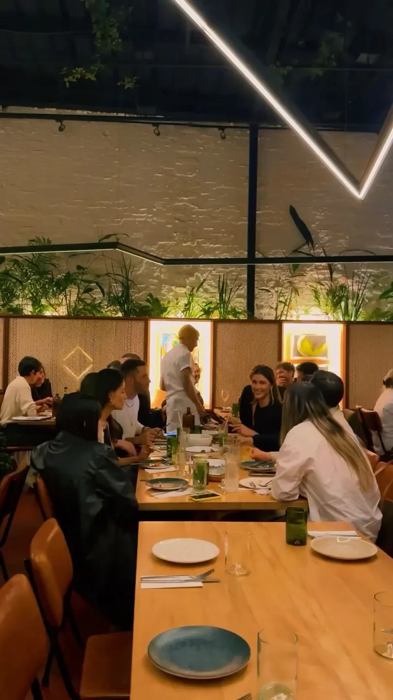 Dining at Salvo Patria restaurant in Bogota, featuring groups enjoying a meal