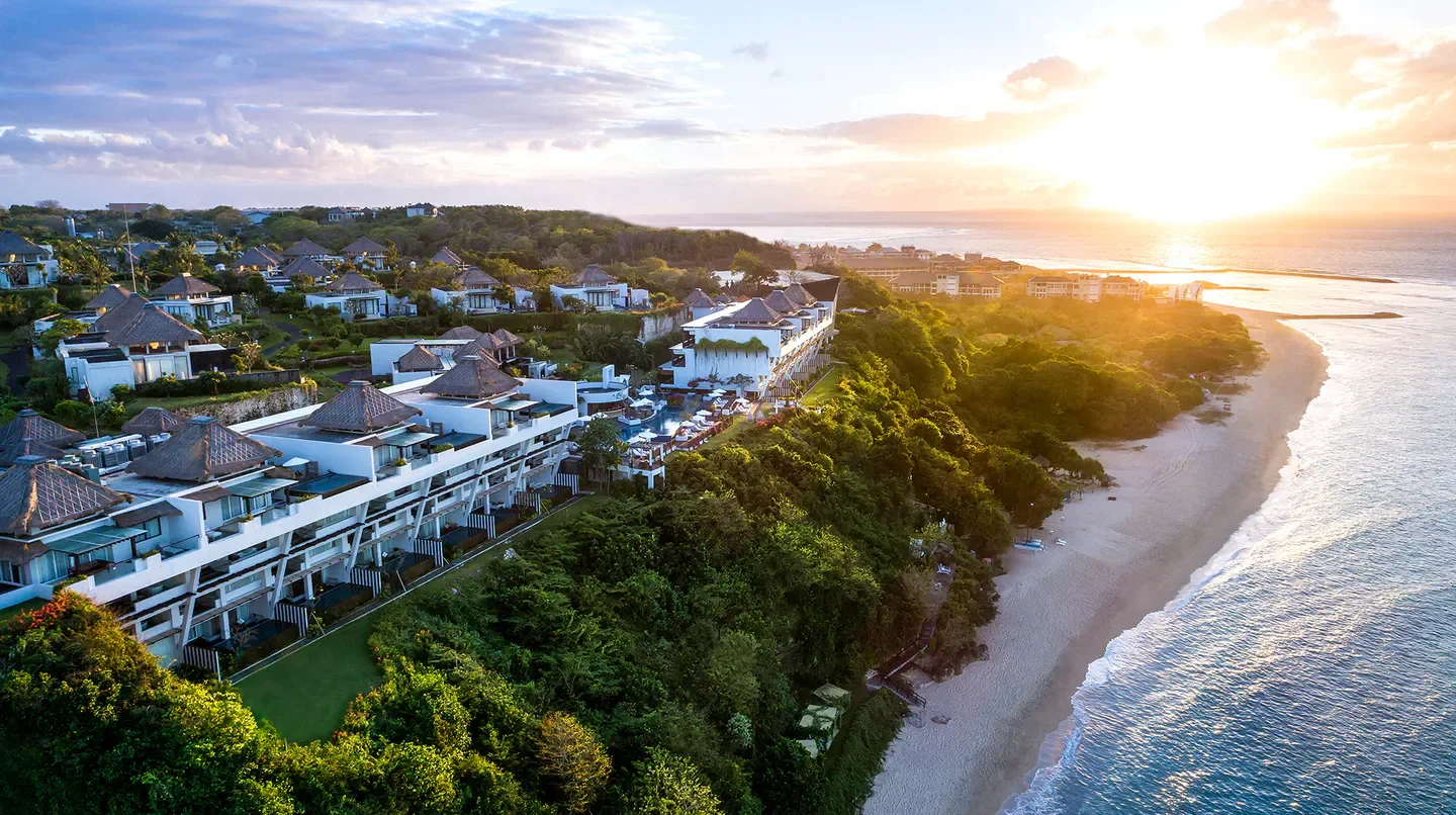 Aerial view of Samabe Bali Suites & Villas with stunning ocean views in Bali at sunset