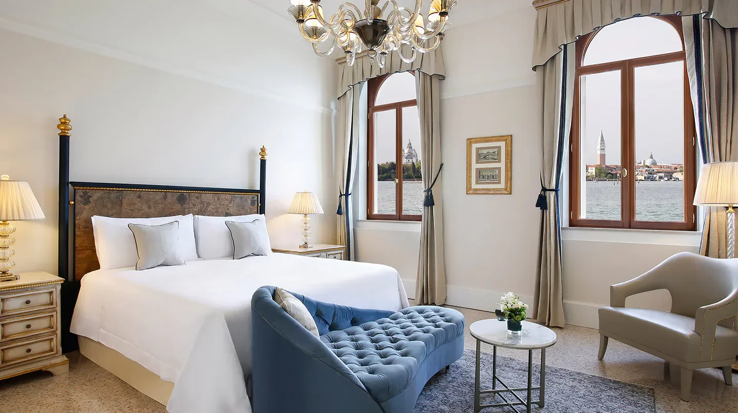 Elegant bedroom at San Clemente Palace Kempinski in Venice with stunning views.