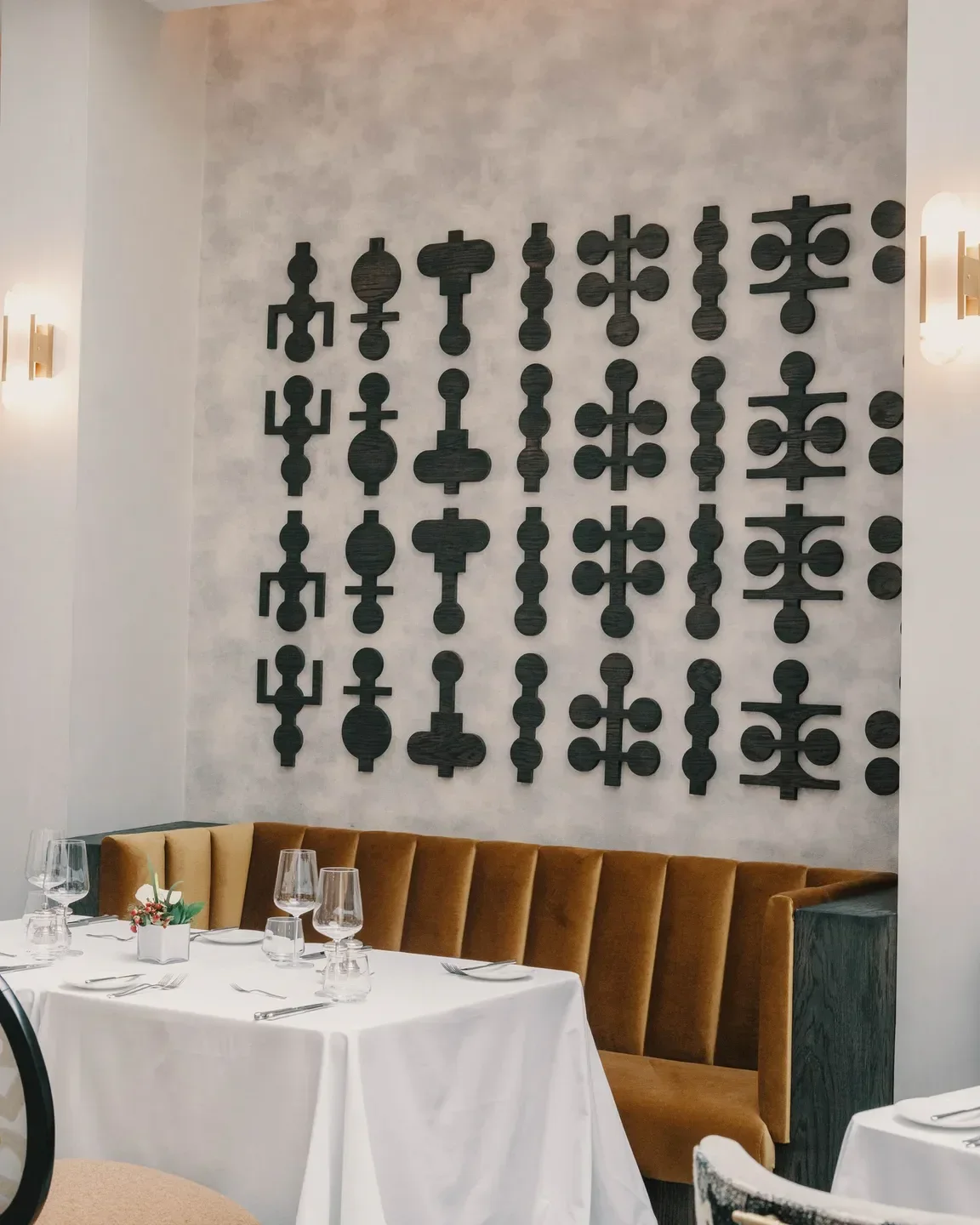 Dining space at Saxon Hotel, Villas & Spa in Johannesburg, with art and velvet booth.