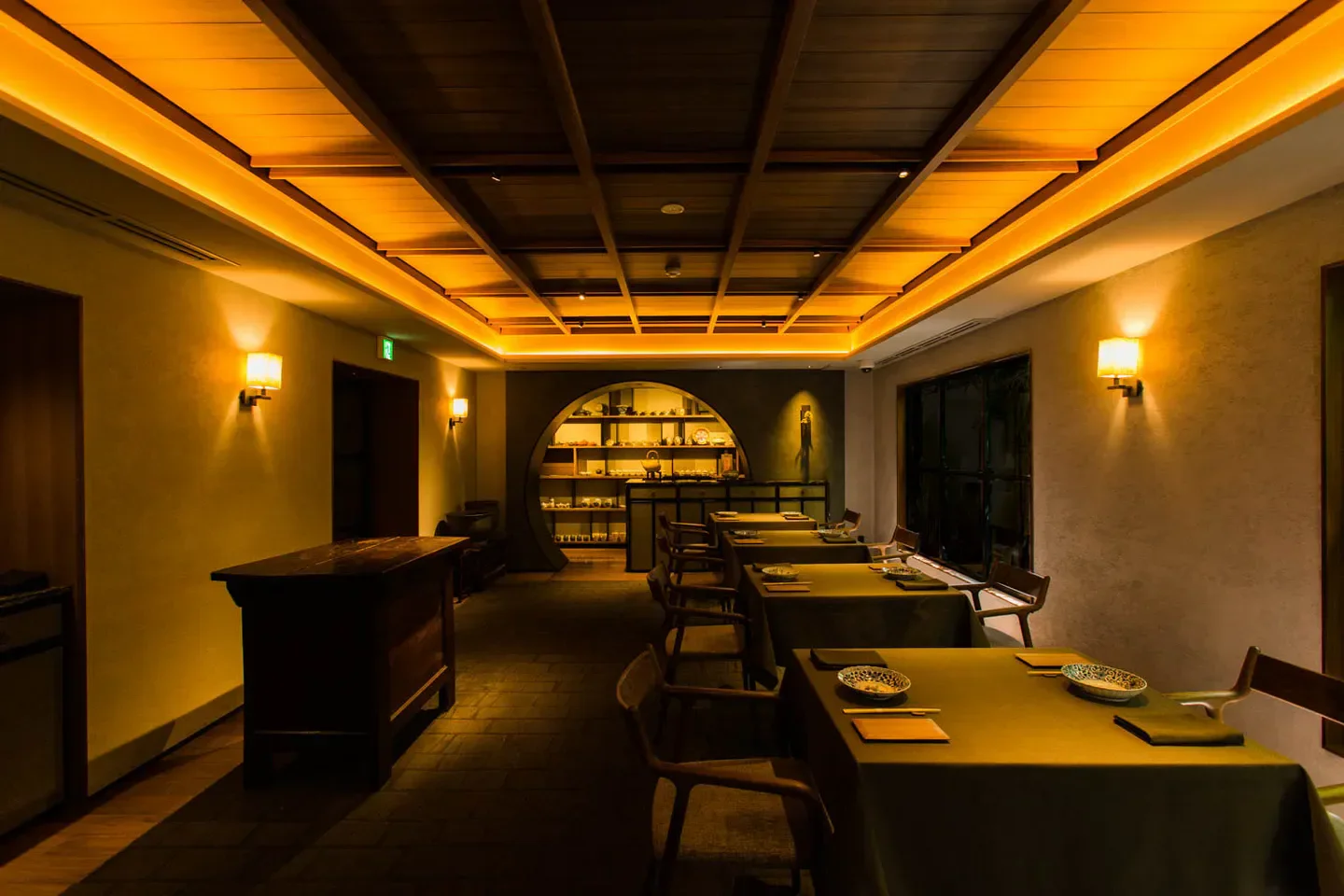 Interior dining space at Sazenka in Tokyo, featuring warm lighting and elegant table settings.