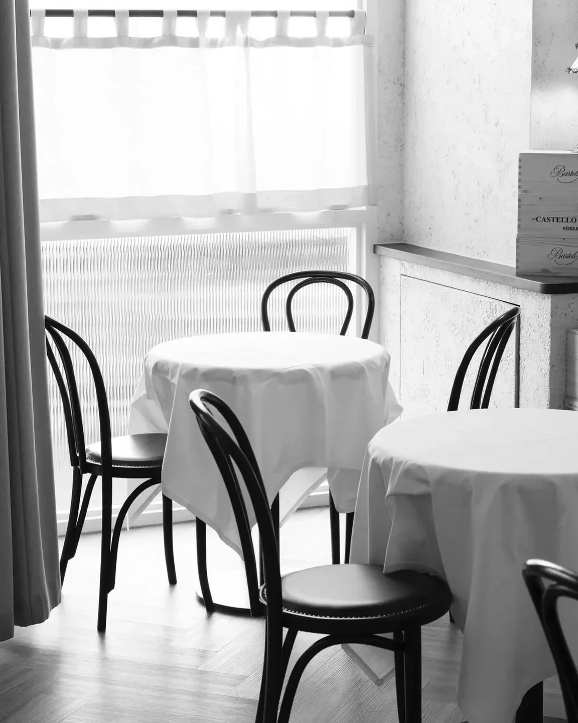 Elegant dining tables inside Scopri restaurant, Melbourne, with classic chairs and natural light.