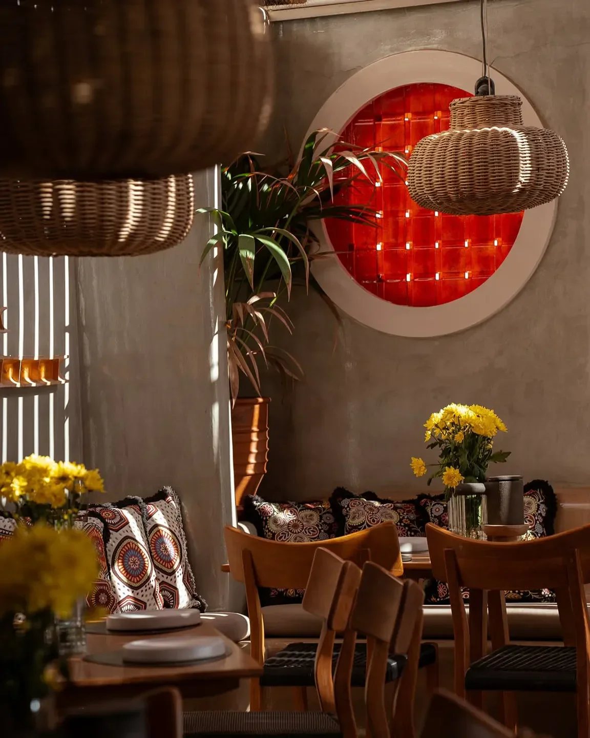 Cozy dining area at Seaside restaurant in Santorini with stylish decor and flowers