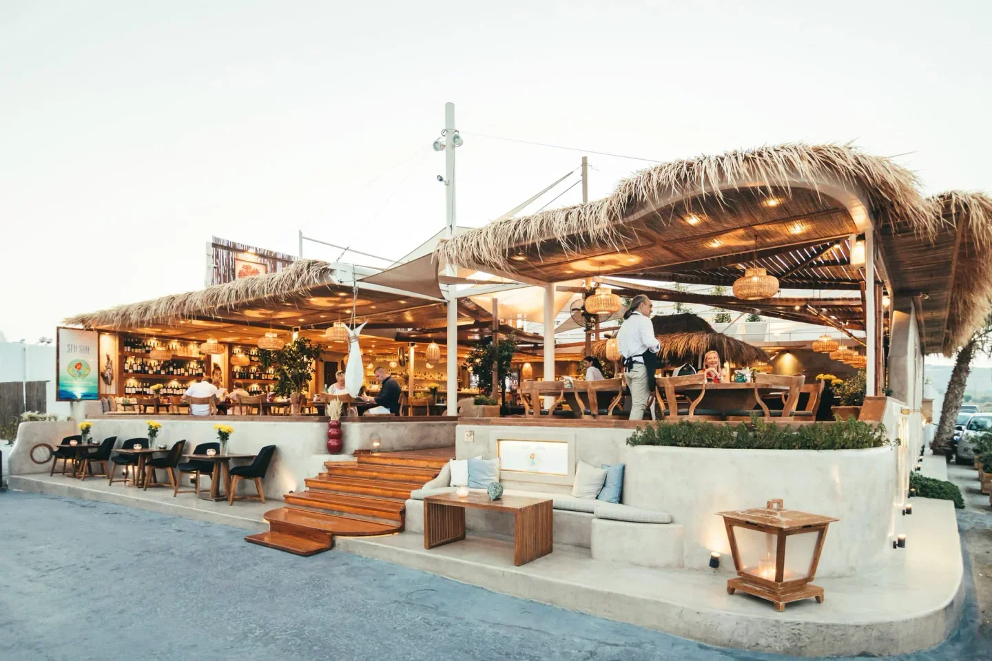Seaside Beach Club in Santorini, outdoor dining with stylish, modern design