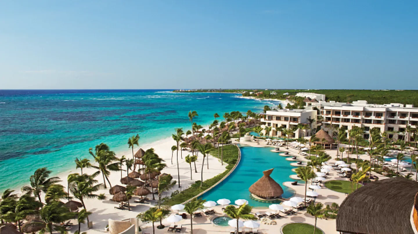 Aerial view of Secrets Akumal Riviera Maya resort in Tulum, Mexico, with turquoise waters.