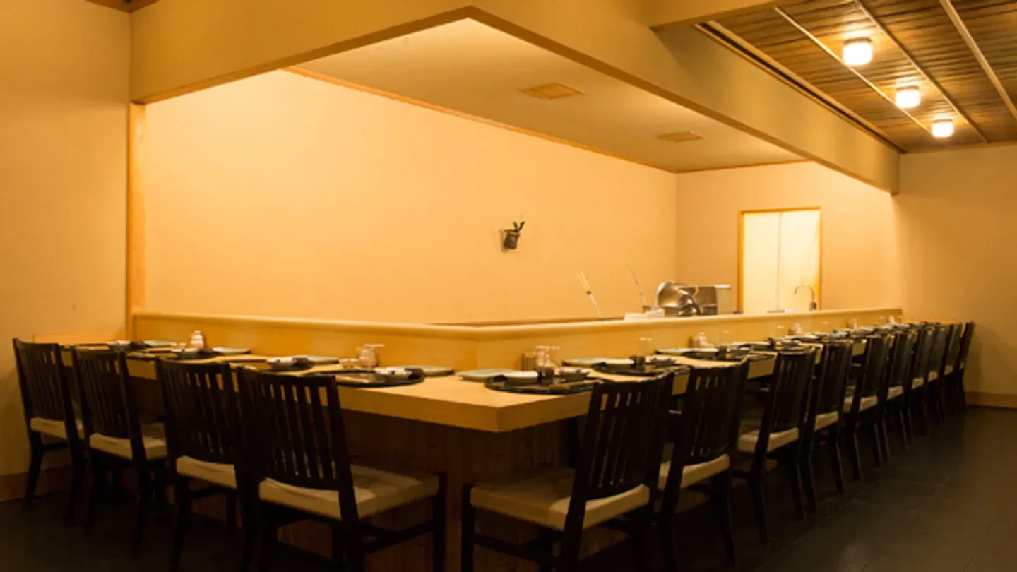 Interior of Seiju restaurant in Tokyo, showcasing a minimalist dining space and wooden tables.