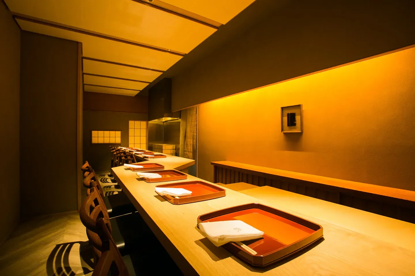 Interior of Sen restaurant in Kyoto, with sleek table settings and warm lighting.