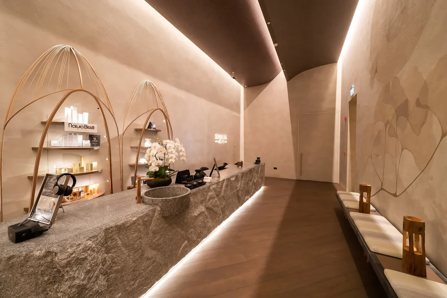 Reception area at SENSASIA Stories Spa in Dubai with natural stone counter.