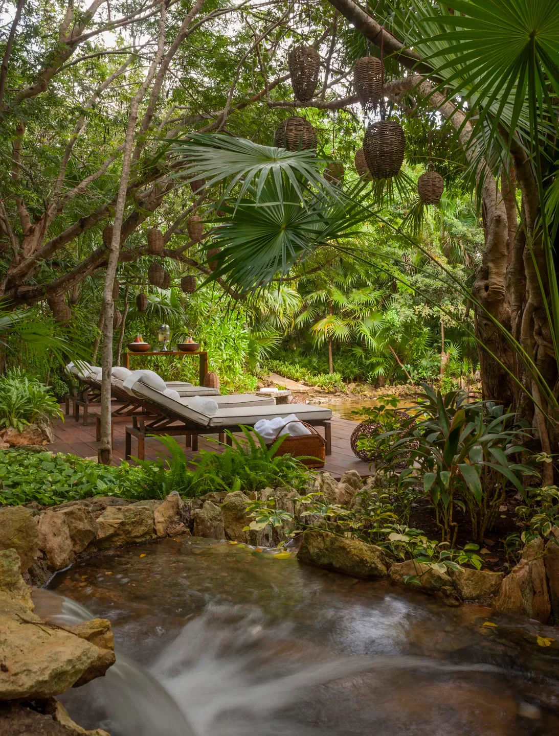 Tranquil outdoor spa at Sense, A Rosewood Spa at Mayakoba in Riviera Maya, with stream and lounge chairs