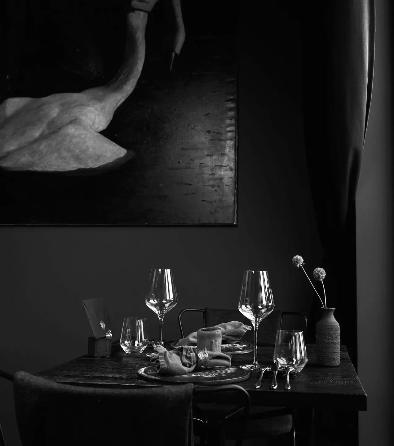 Elegant dining scene at Seven Swans restaurant in Frankfurt, featuring swan art and table setting.