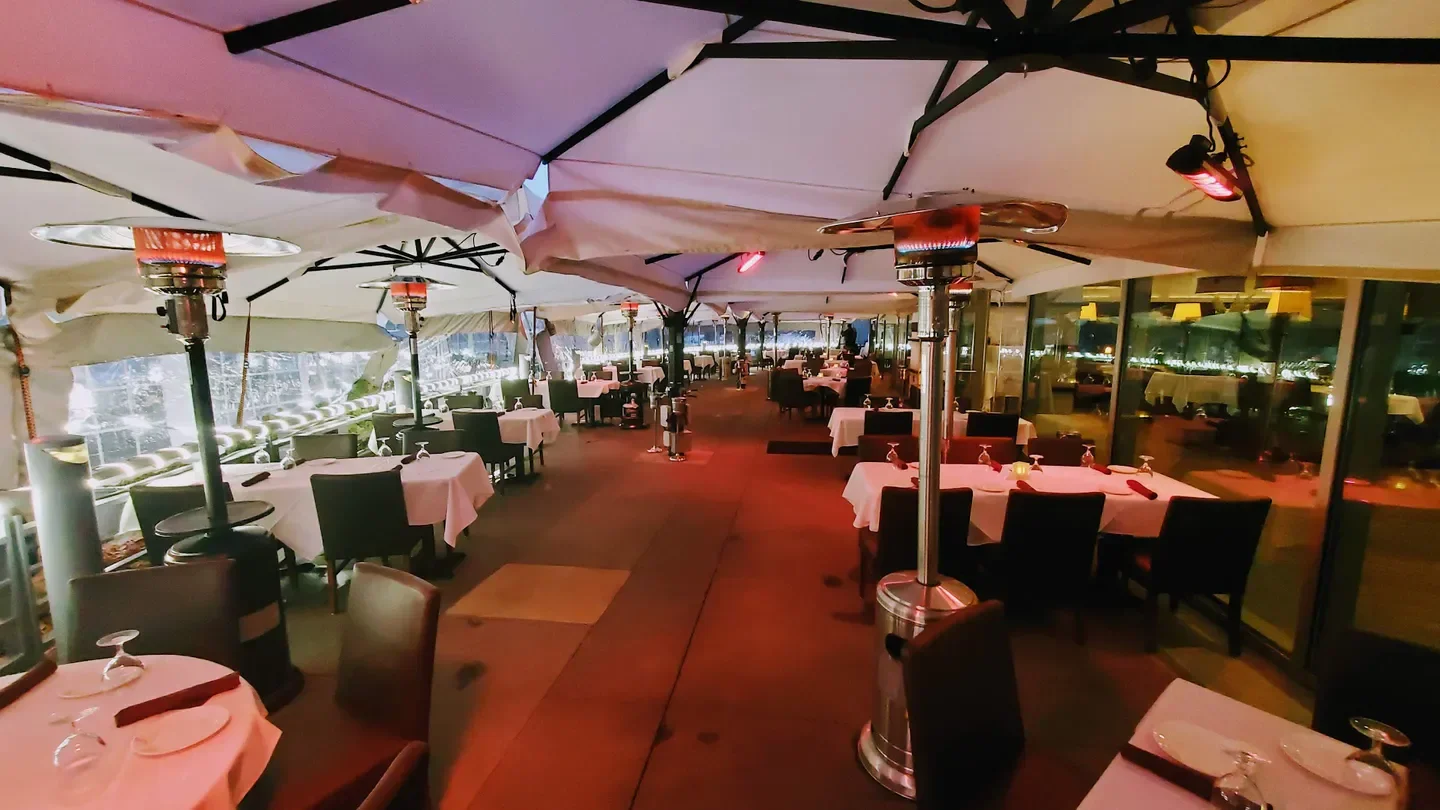 Outdoor dining at Shanahan's Steakhouse in Denver, elegant patio with heaters and tables.