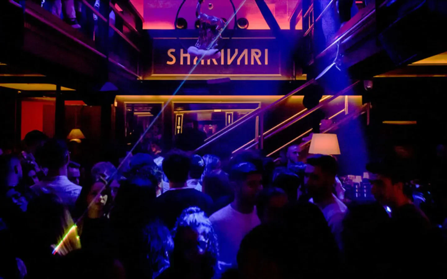 Inside Shari Vari nightclub in Rome, Italy, with neon lights and a crowd