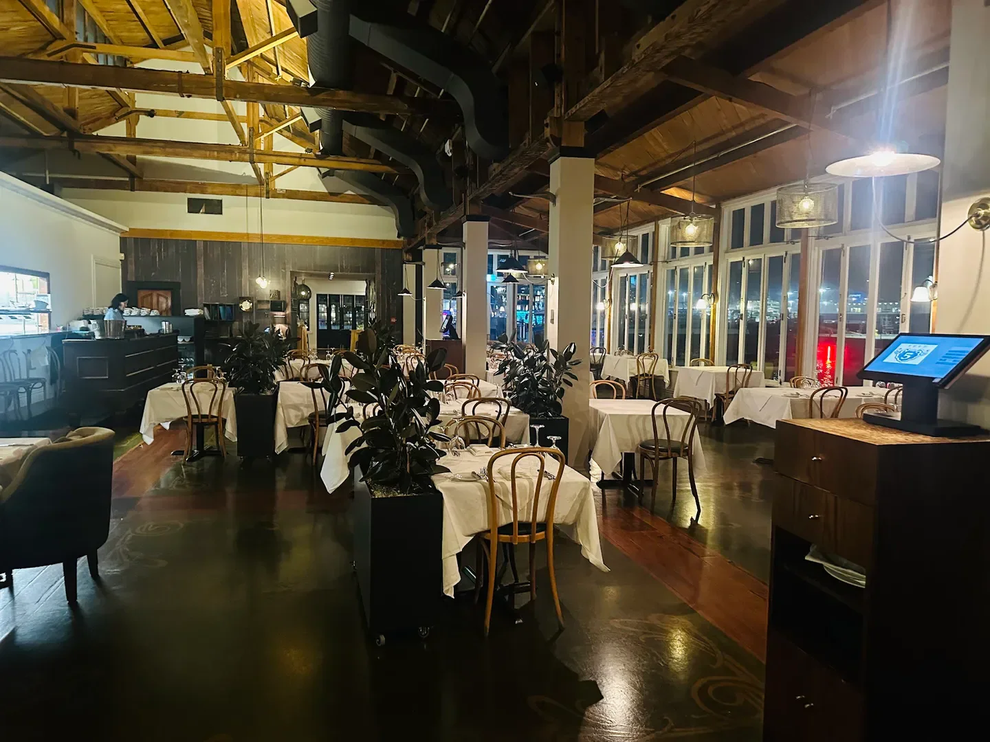 Interior dining at Shed 5 restaurant in Wellington, featuring tables, chairs, and elegant decor.