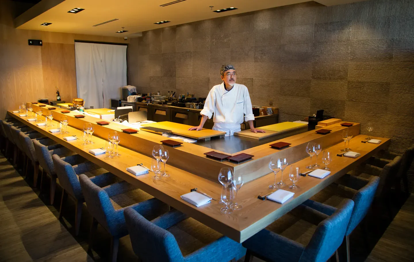 Chef at ShinBay restaurant in Phoenix, preparing for service at the sushi bar.