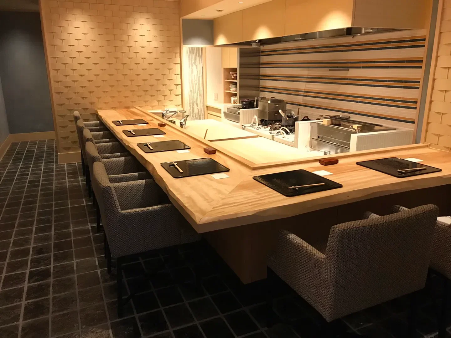 Shinchi Yamamoto restaurant in Osaka with a modern sushi bar and seating area.