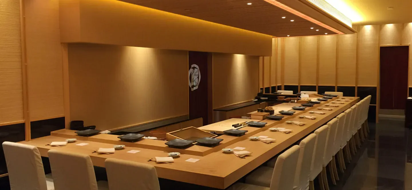 Interior dining space at Shinji (Bras Basah Road) in Singapore, featuring sushi bar setup.