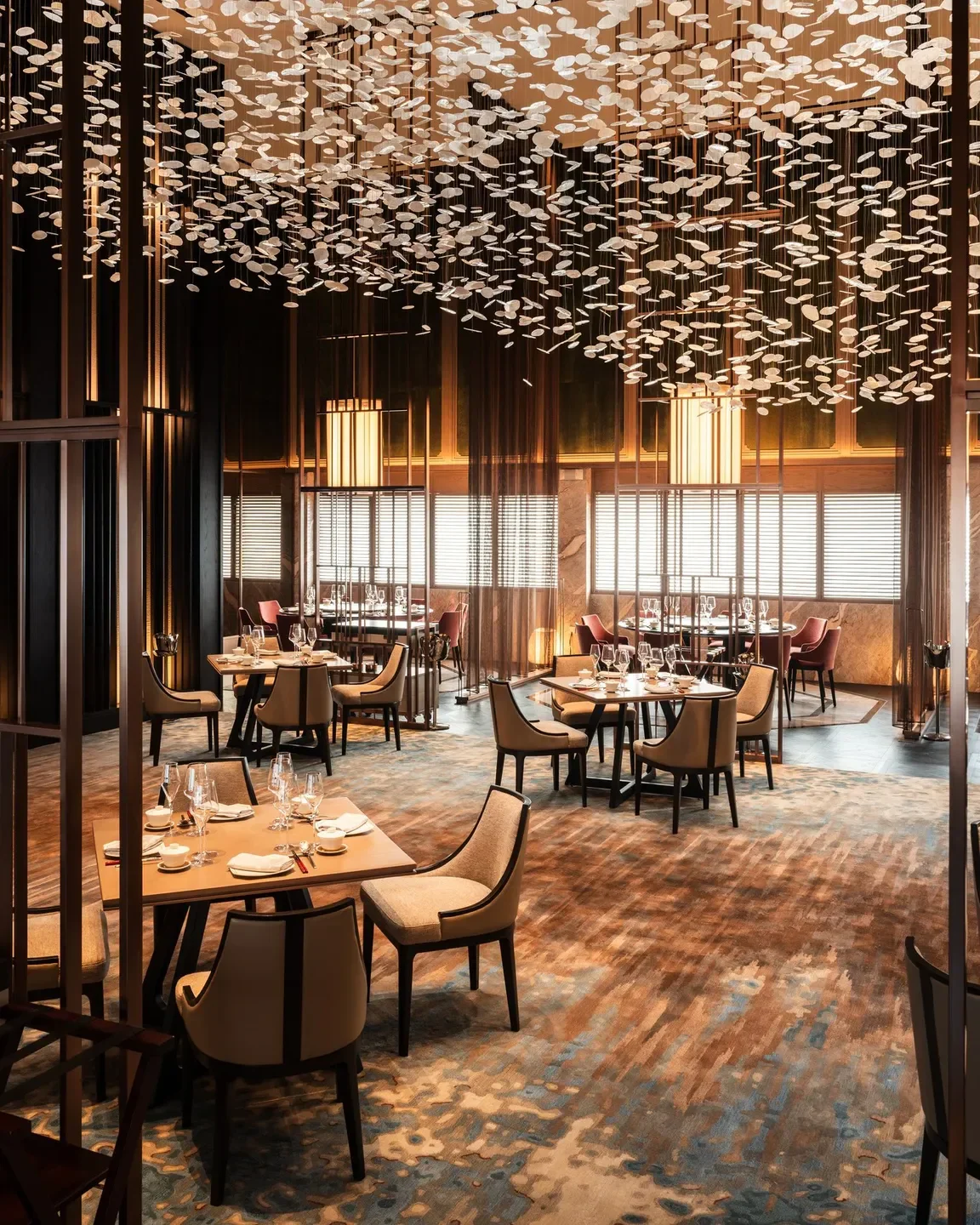 Elegant interior of Shisen Hanten restaurant in Singapore, showcasing stylish dining tables and lighting.