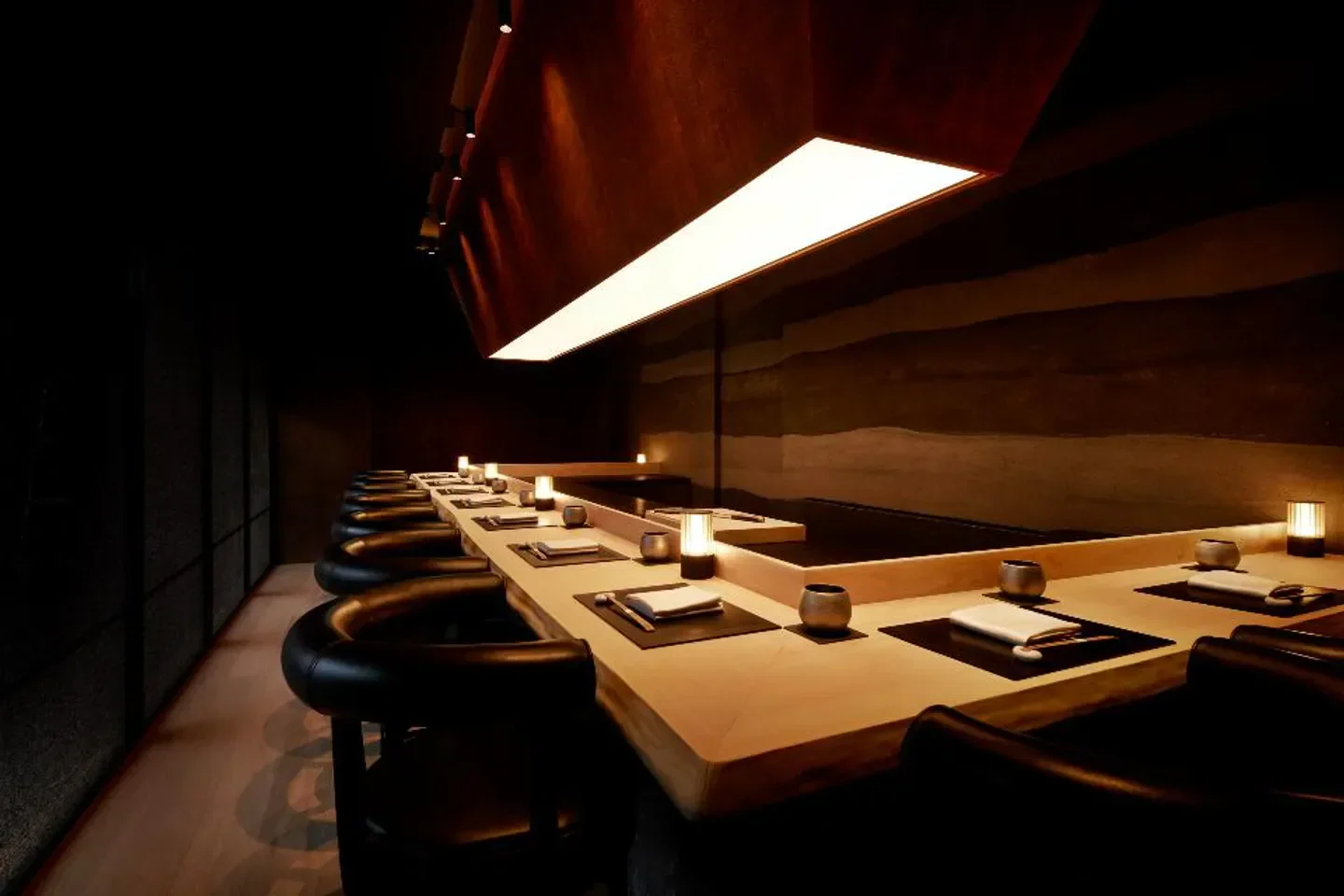 Interior of Shoukouwa in Singapore, featuring an elegant sushi counter and seating.