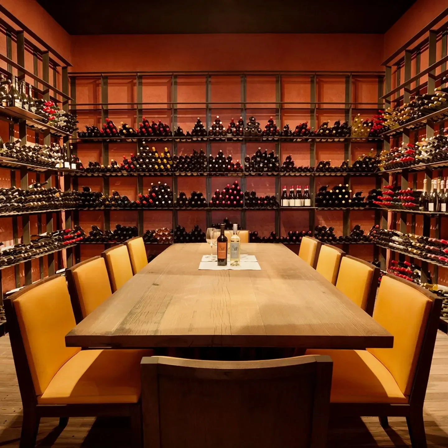 Wine cellar dining at Siete Fuegos Restaurant, Mendoza, with a long wooden table and chairs