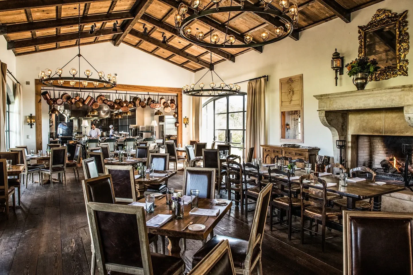 Elegant dining room at Signature restaurant in San Antonio, featuring a fireplace and copper pans.