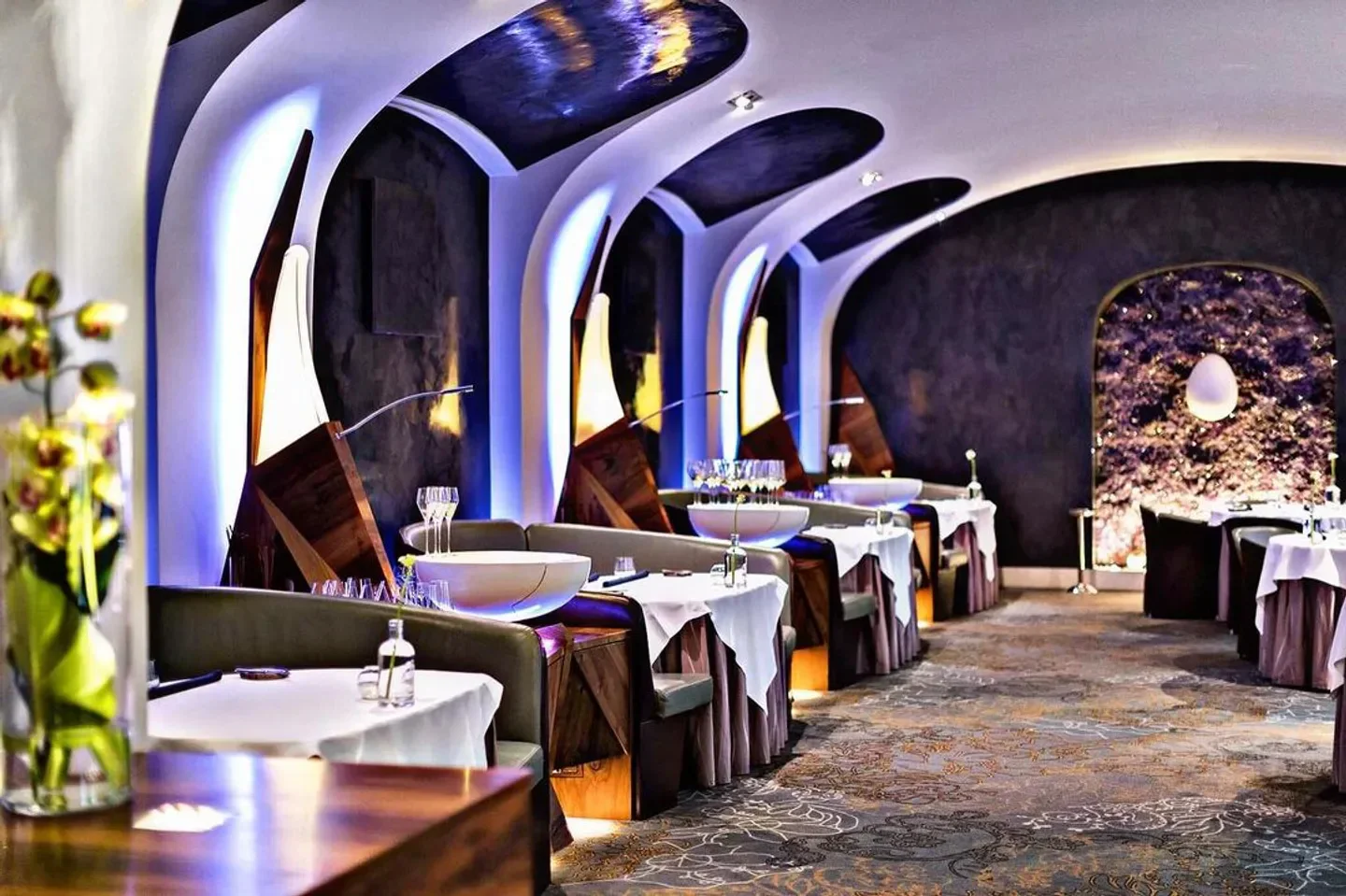 Elegant interior of Silvio Nickol Gourmet Restaurant in Vienna, featuring stylish lighting and tables.
