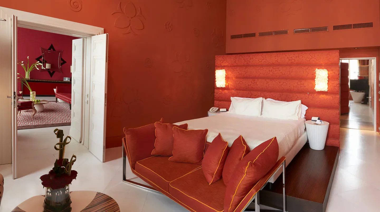 Elegant bedroom at Sina Centurion Palace hotel in Venice, featuring orange decor.
