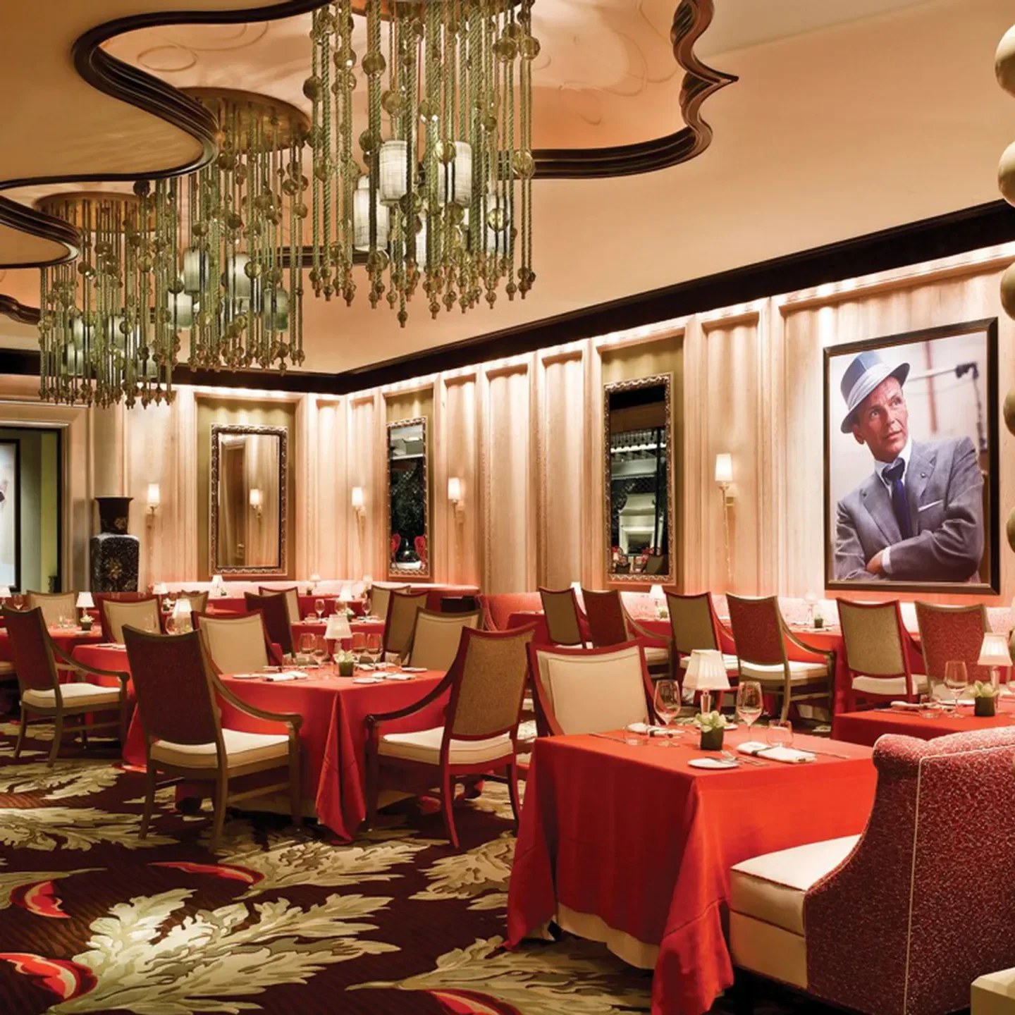 Sinatra restaurant in Las Vegas, featuring red tables and a portrait of Frank Sinatra.